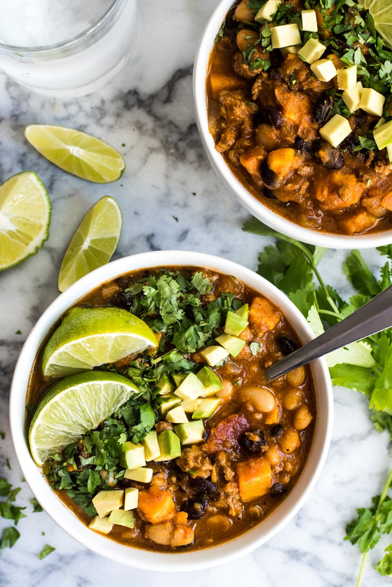 Turkey Chili made with pumpkin in a white bowl on a marble table