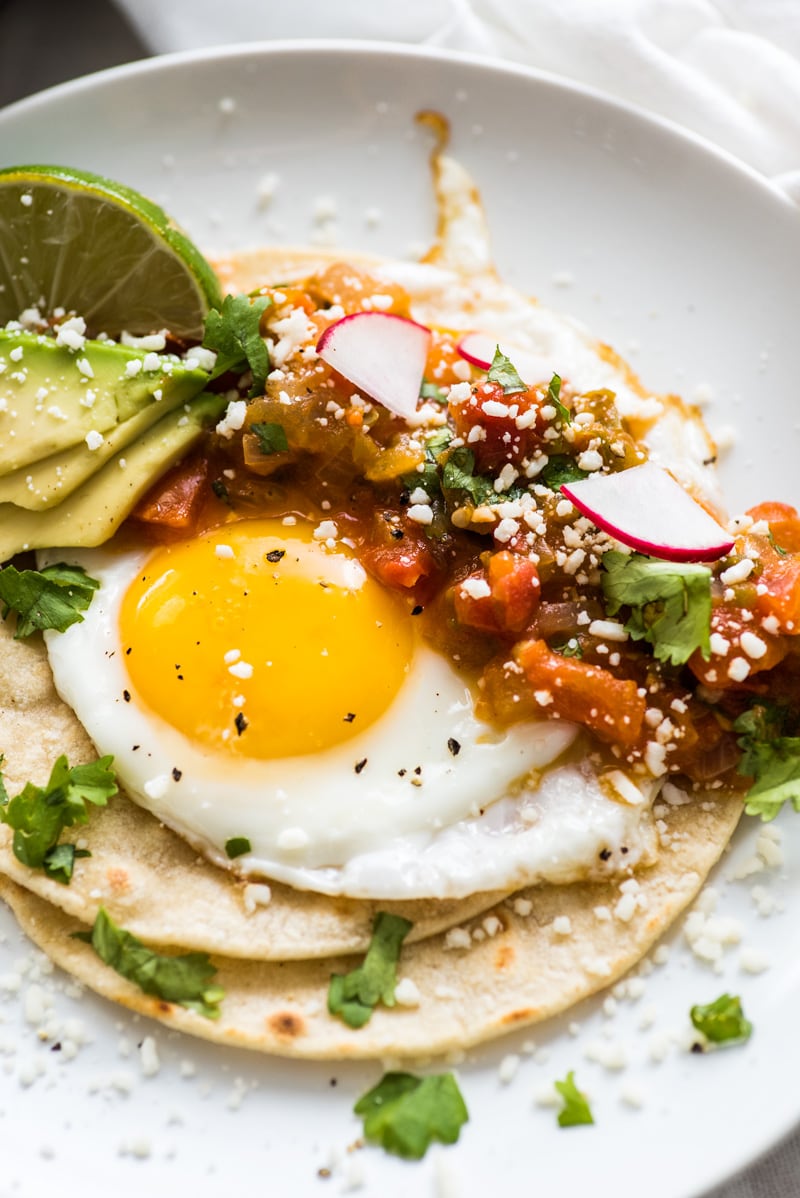 Huevos rancheros made from crispy corn tortillas, a fried egg, and salsa.