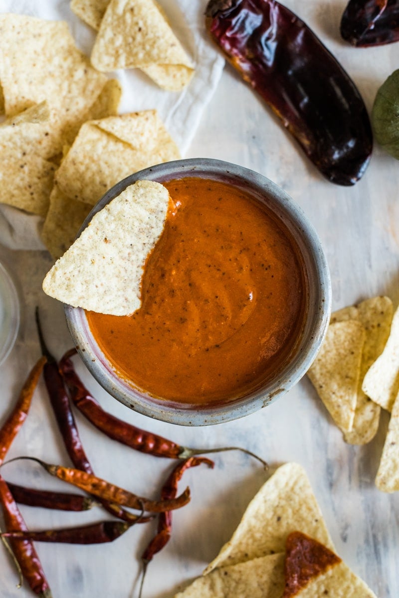 This Toasted Red Chile Salsa made with dried Arbol and New Mexico chiles, tomatillos and garlic is easy to make and perfectly spicy. Add to eggs, tacos and more!