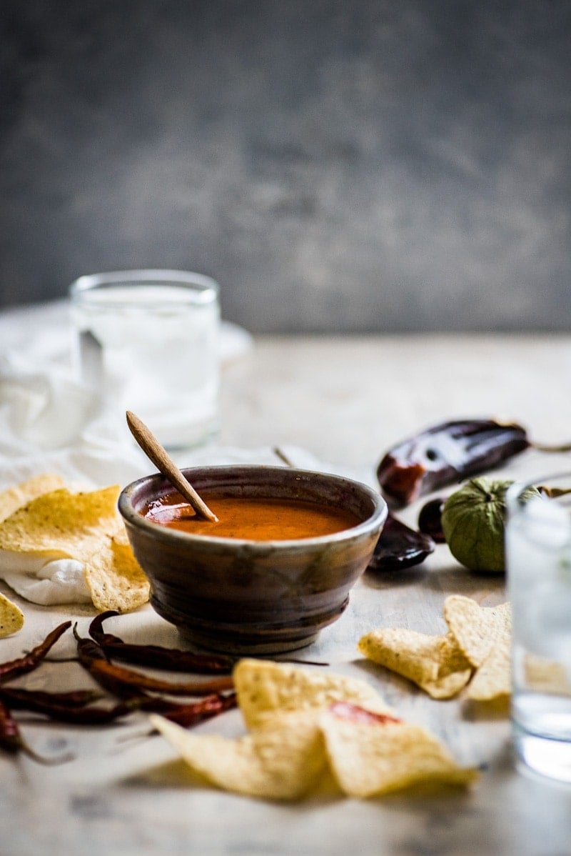 This Toasted Red Chile Salsa made with dried Arbol and New Mexico chiles, tomatillos and garlic is easy to make and perfectly spicy. Add to eggs, tacos and more!