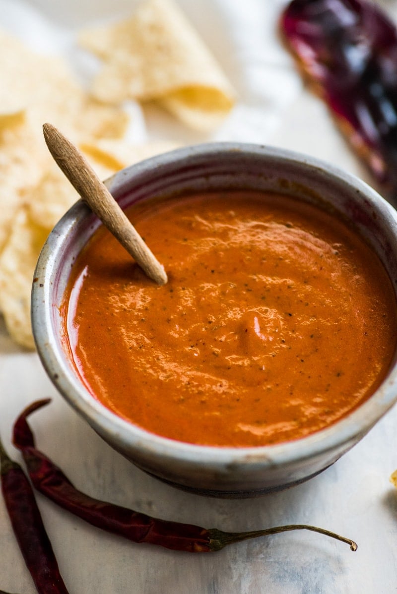 This Toasted Red Chile Salsa made with dried Arbol and New Mexico chiles, tomatillos and garlic is easy to make and perfectly spicy. Add to eggs, tacos and more!