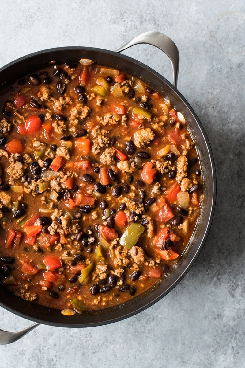 A pot filled with chorizo chili made with black beans.