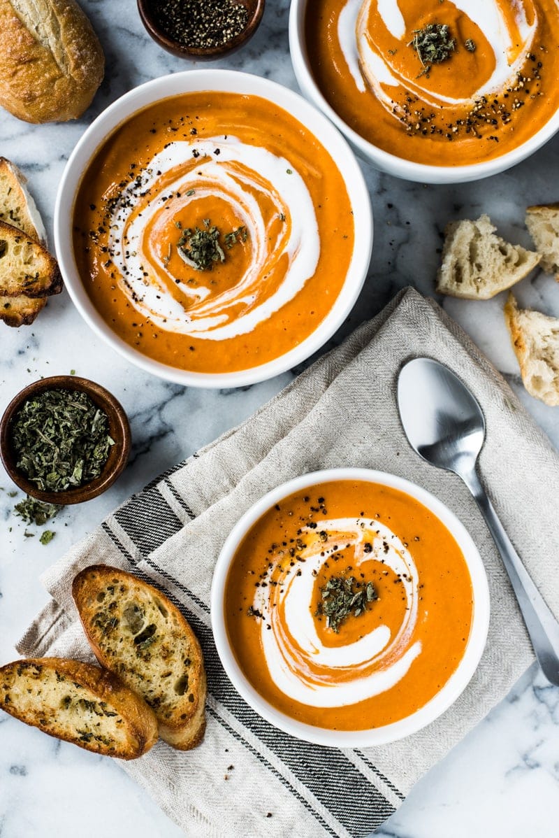 This Smoky Chipotle Tomato Bisque recipe is made with roasted butternut squash, corn and tomatoes for a healthy and comforting lunch and dinner. (gluten free, paleo, vegetarian, vegan)