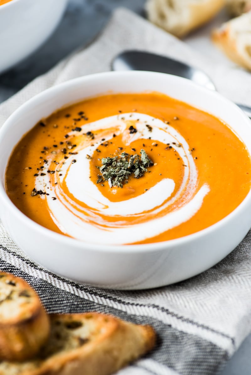This Smoky Chipotle Tomato Bisque recipe is made with roasted butternut squash, corn and tomatoes for a healthy and comforting lunch and dinner. (gluten free, paleo, vegetarian, vegan)