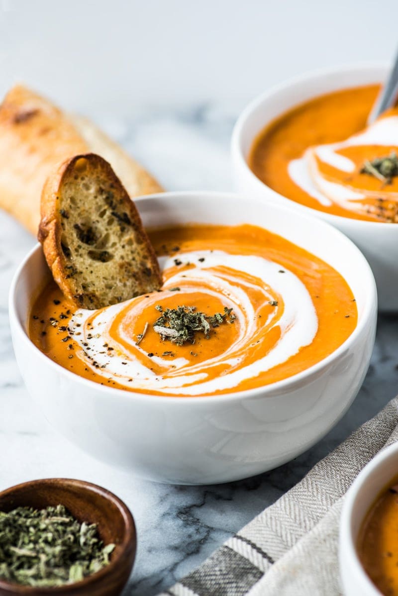 This Smoky Chipotle Tomato Bisque recipe is made with roasted butternut squash, corn and tomatoes for a healthy and comforting lunch and dinner. (gluten free, paleo, vegetarian, vegan)