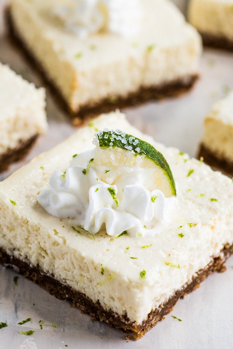 These Margarita Cheesecake Bars are creamy, made with a touch of tequila and sit on a buttery graham cracker crust.