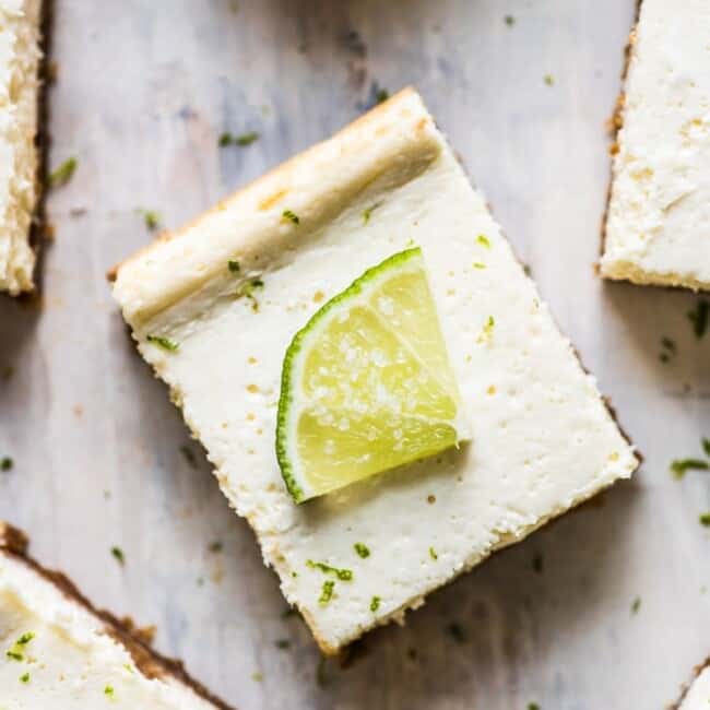 These Margarita Cheesecake Bars are creamy, made with a touch of tequila and sit on a buttery graham cracker crust.