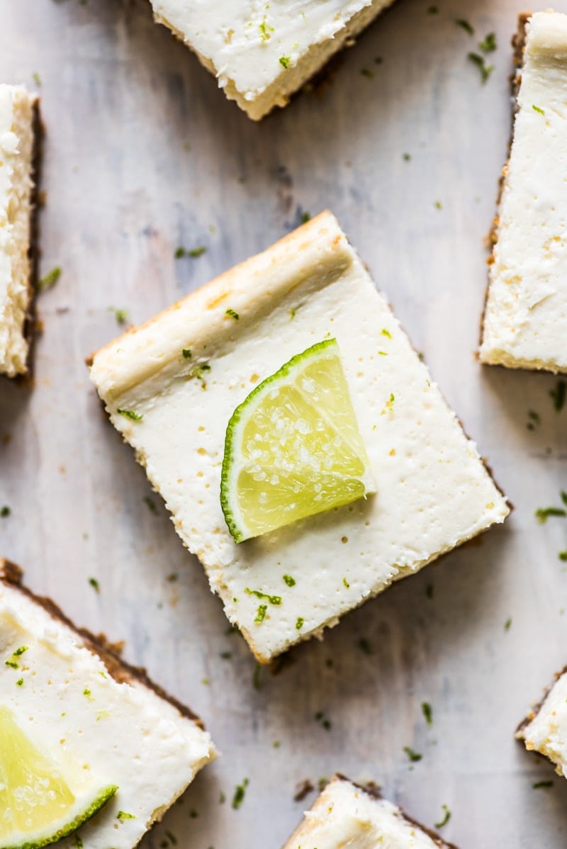 These Margarita Cheesecake Bars are creamy, made with a touch of tequila and sit on a buttery graham cracker crust.