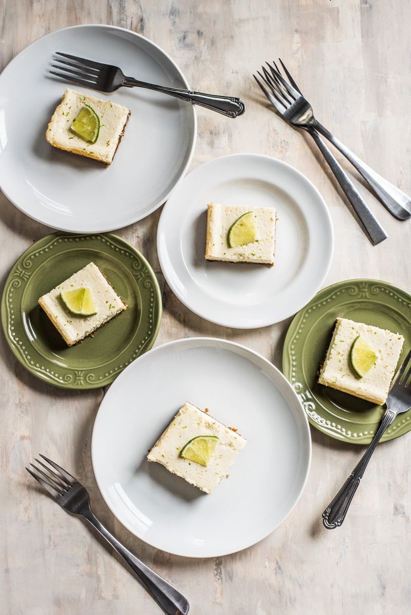 These Margarita Cheesecake Bars are creamy, made with a touch of tequila and sit on a buttery graham cracker crust.