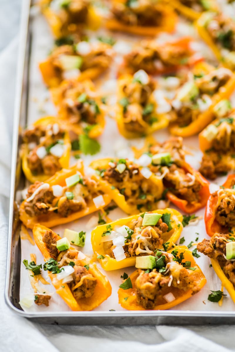 This Healthy Chicken Nachos recipe is made with mini bell peppers instead of tortilla chips! It's Low carb, gluten free and grain free!