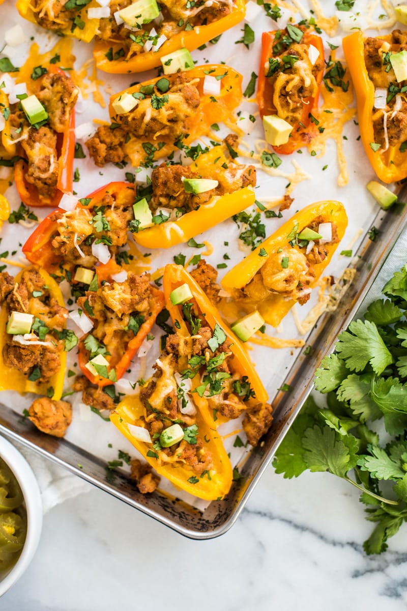 This Healthy Chicken Nachos recipe is made with mini bell peppers instead of tortilla chips! It's Low carb, gluten free and grain free!