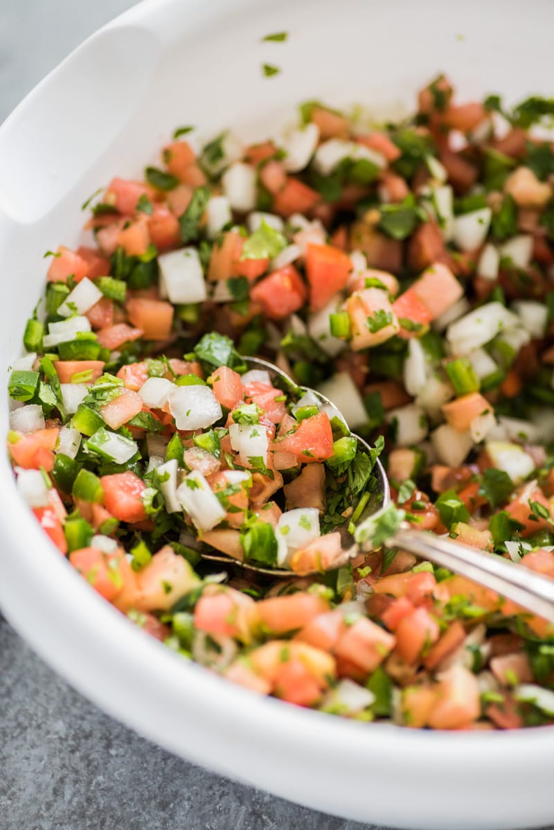 This Mexican Pico de Gallo recipe is made with fresh tomatoes, onions, jalapenos, cilantro and salt for a naturally gluten free, low carb, paleo, vegetarian and vegan salsa and appetizer!