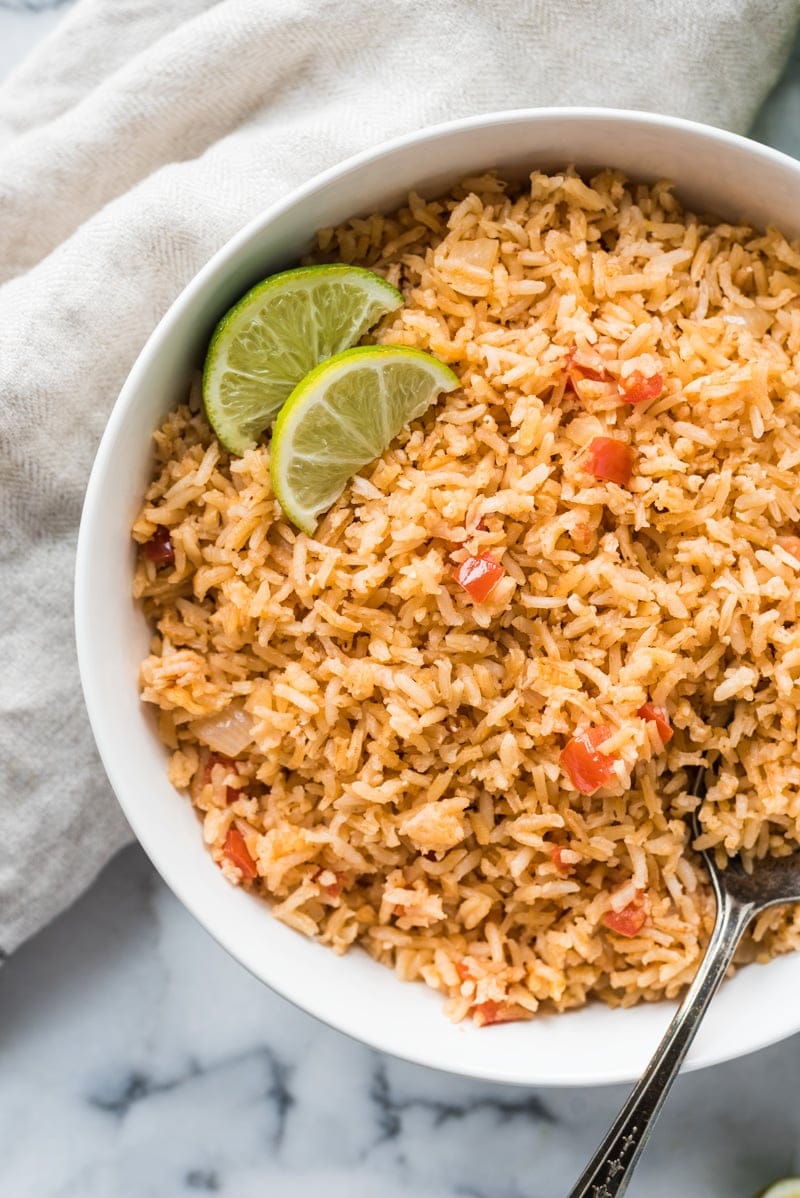My Mom's Authentic Mexican Rice Recipe is made with simple ingredients like chopped tomatoes, onions and garlic and is the perfect side dish for any meal.