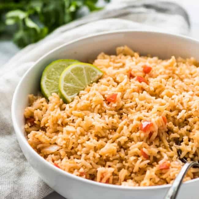 My Mom's Authentic Mexican Rice Recipe is made with simple ingredients like chopped tomatoes, onions and garlic and is the perfect side dish for any meal.