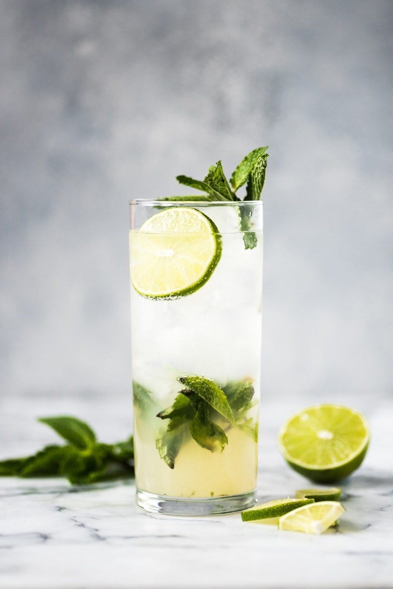 A classic mojito cocktail in a tall glass filled with ice.