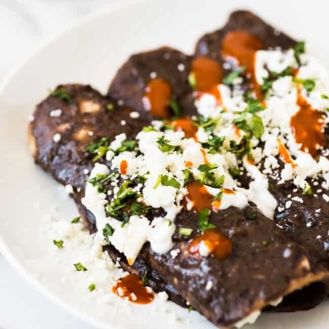 Enfrijoladas - Mexican enchiladas covered in a black bean sauce stuffed with cheese and ready in only 15 minutes! (vegetarian, gluten free)