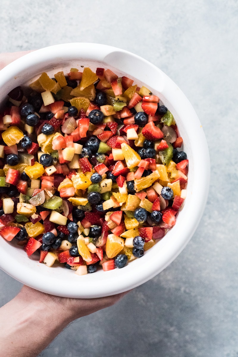 This Fruit Salsa with Cinnamon Chips recipe is made with 6 different types of fruit and is served with baked cinnamon sugar tortilla chips for a fun appetizer or healthy dessert!