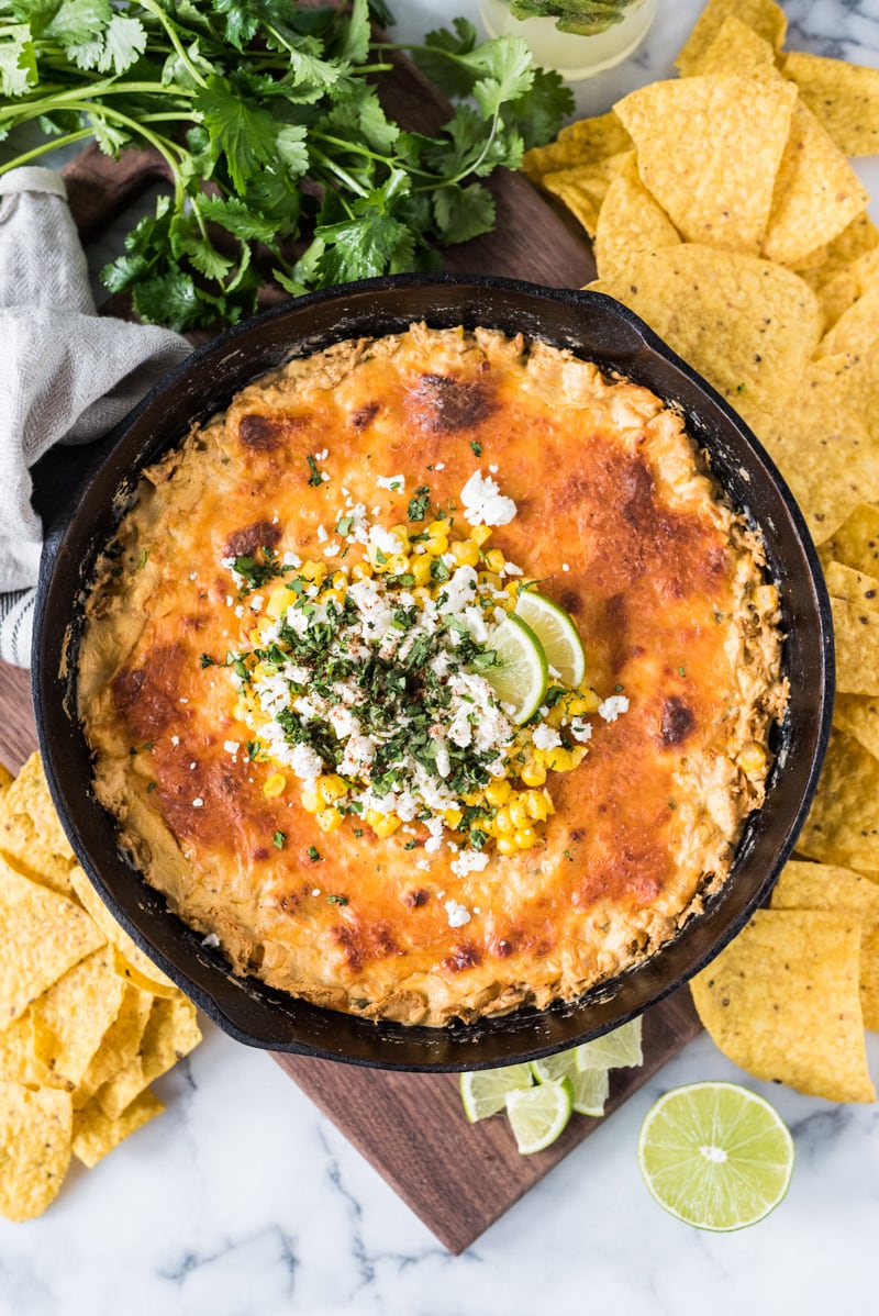 This Mexican Corn Dip recipe made whole kernel corn, lots of cheese and a blend Mexican spices is creamy, satisfying and addicting. It's the perfect appetizer for parties and celebrations like Cinco de Mayo!