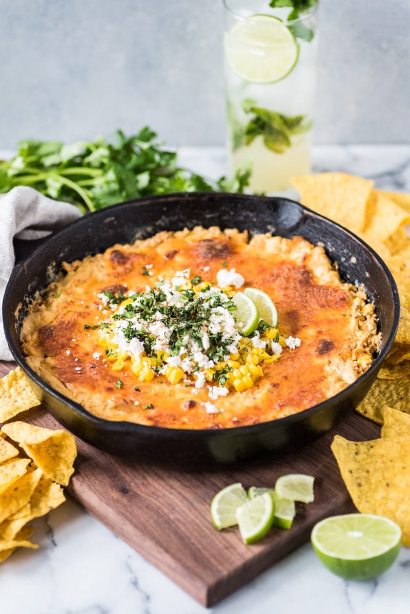 This Mexican Corn Dip recipe made whole kernel corn, lots of cheese and a blend Mexican spices is creamy, satisfying and addicting. It's the perfect appetizer for parties and celebrations like Cinco de Mayo!