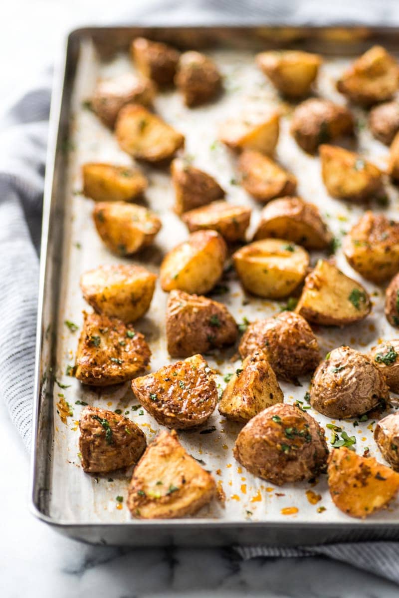 These Mexican Crispy Roasted Potatoes seasoned with chili powder, garlic, sea salt and Parmesan cheese are baked, not fried and are the perfect side to weekday meals. (gluten free, vegetarian)