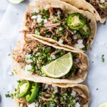Seasoned with oregano, cumin, chili powder, lime juice, these Mexican Slow Cooker Pork Carnitas Tacos are the perfect meal for any night of the week. (gluten free, dairy free, paleo, healthy, clean eating) // isabeleats.com