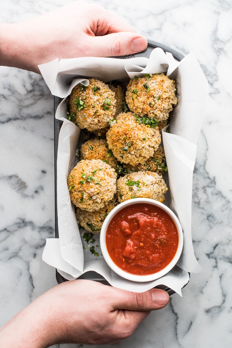 Baked arancini rice balls filled with mozzarella cheese and covered in crispy panko breadcrumbs. Served with a spicy marinara sauce.