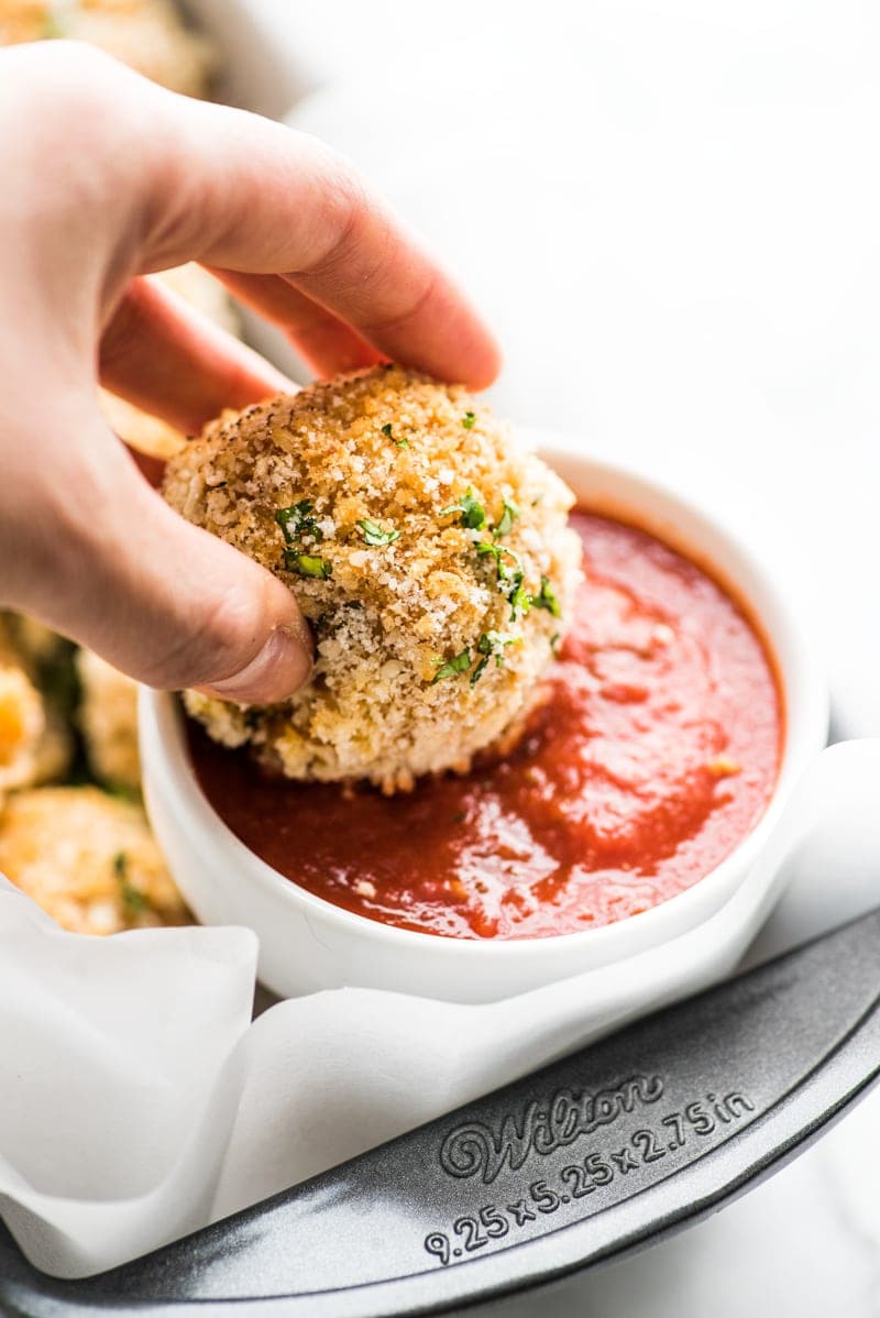 Baked arancini rice balls filled with mozzarella cheese and covered in crispy panko breadcrumbs. Dipped in a spicy marinara sauce.