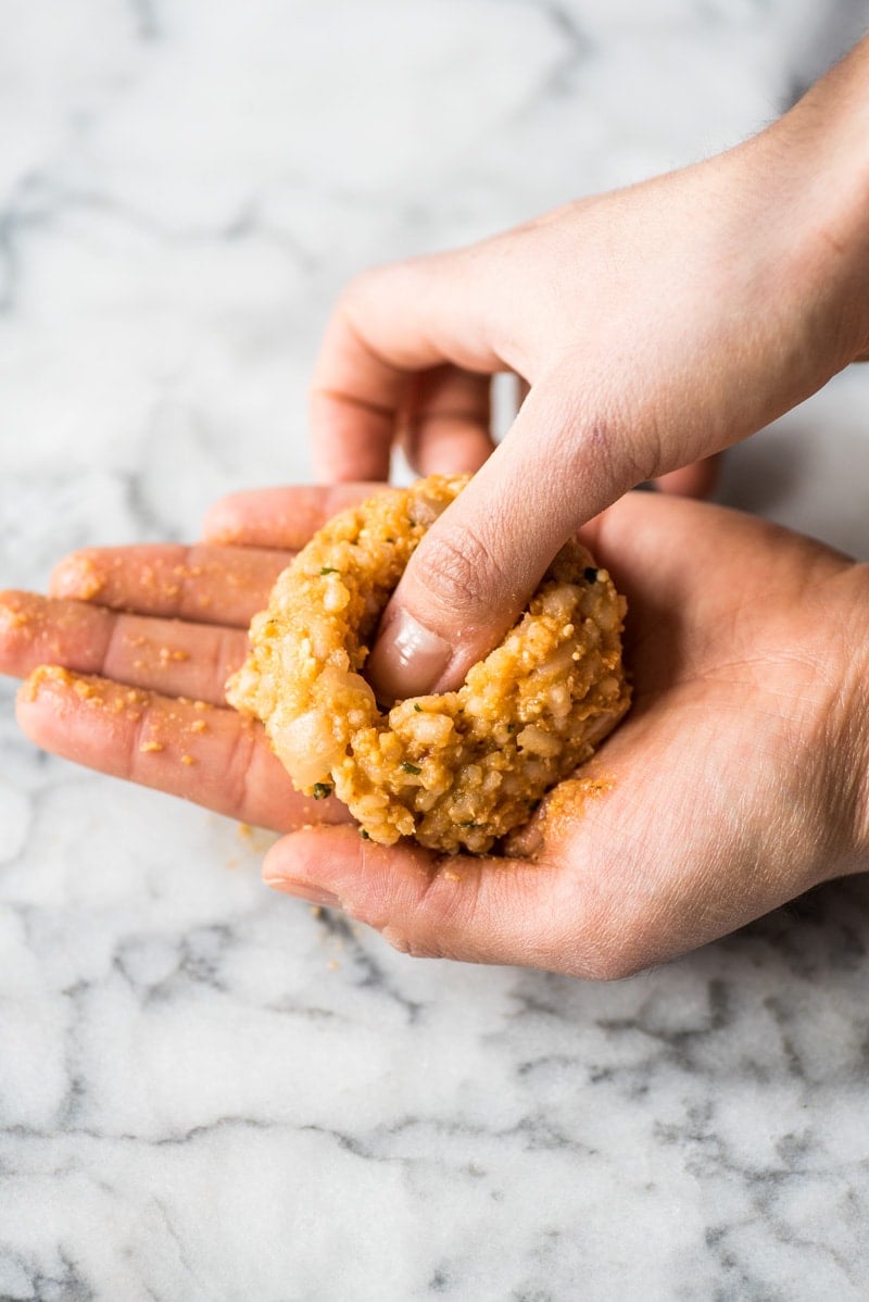 Pressing thumb into the arancini.