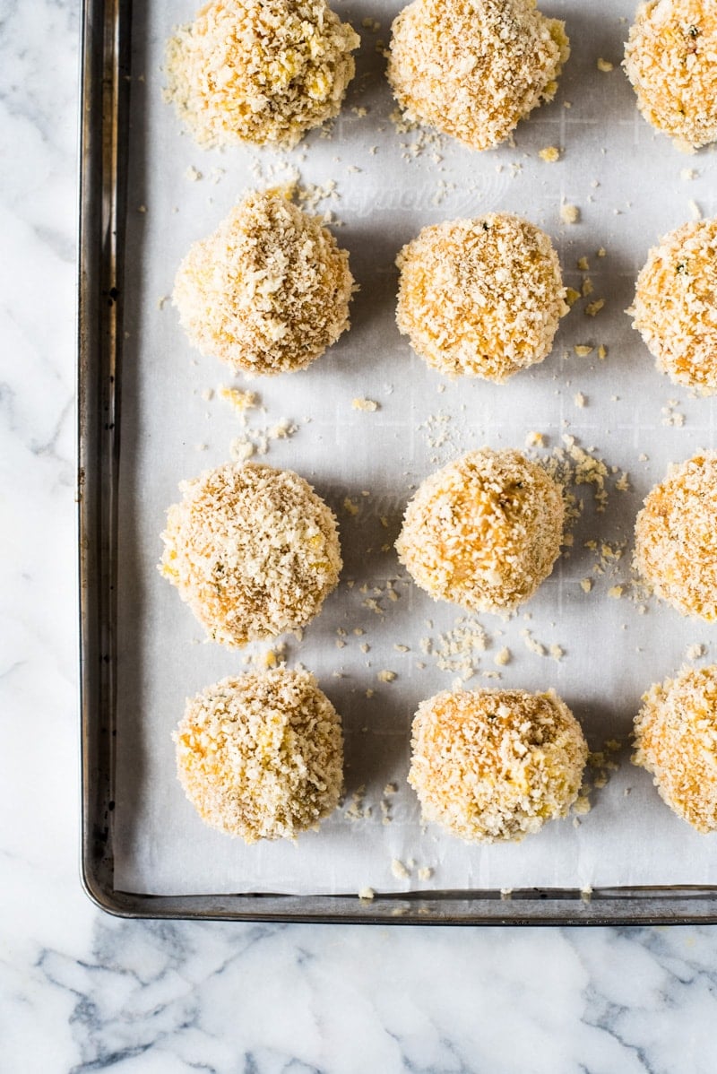 These rice balls rice balls filled with mozzarella cheese and covered in crispy panko breadcrumbs. They're baked, not fried, for a healthier alternative to fried arancini.