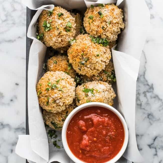 These arancini rice balls are Mexican-spiced savory rice balls filled with melted cheese and covered in crispy panko breadcrumbs baked to golden perfection.