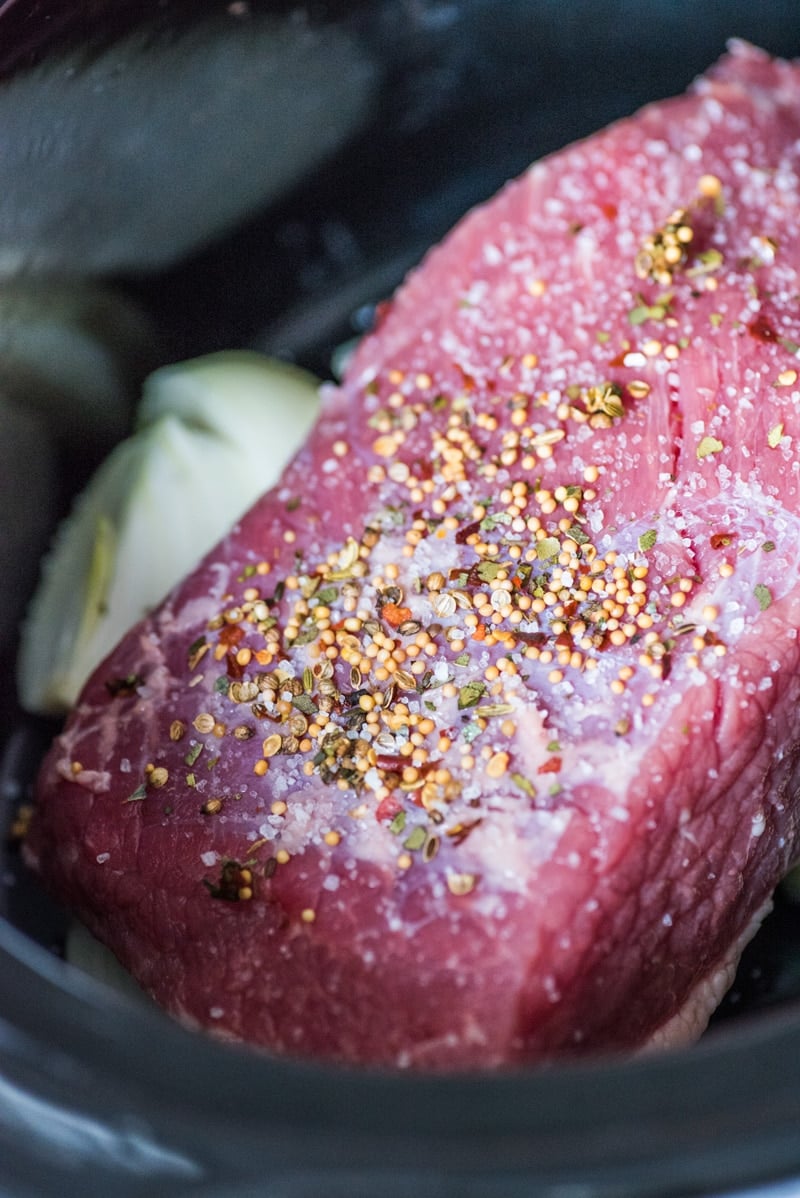 Corned beef brisket in a slow cooker with spice packet