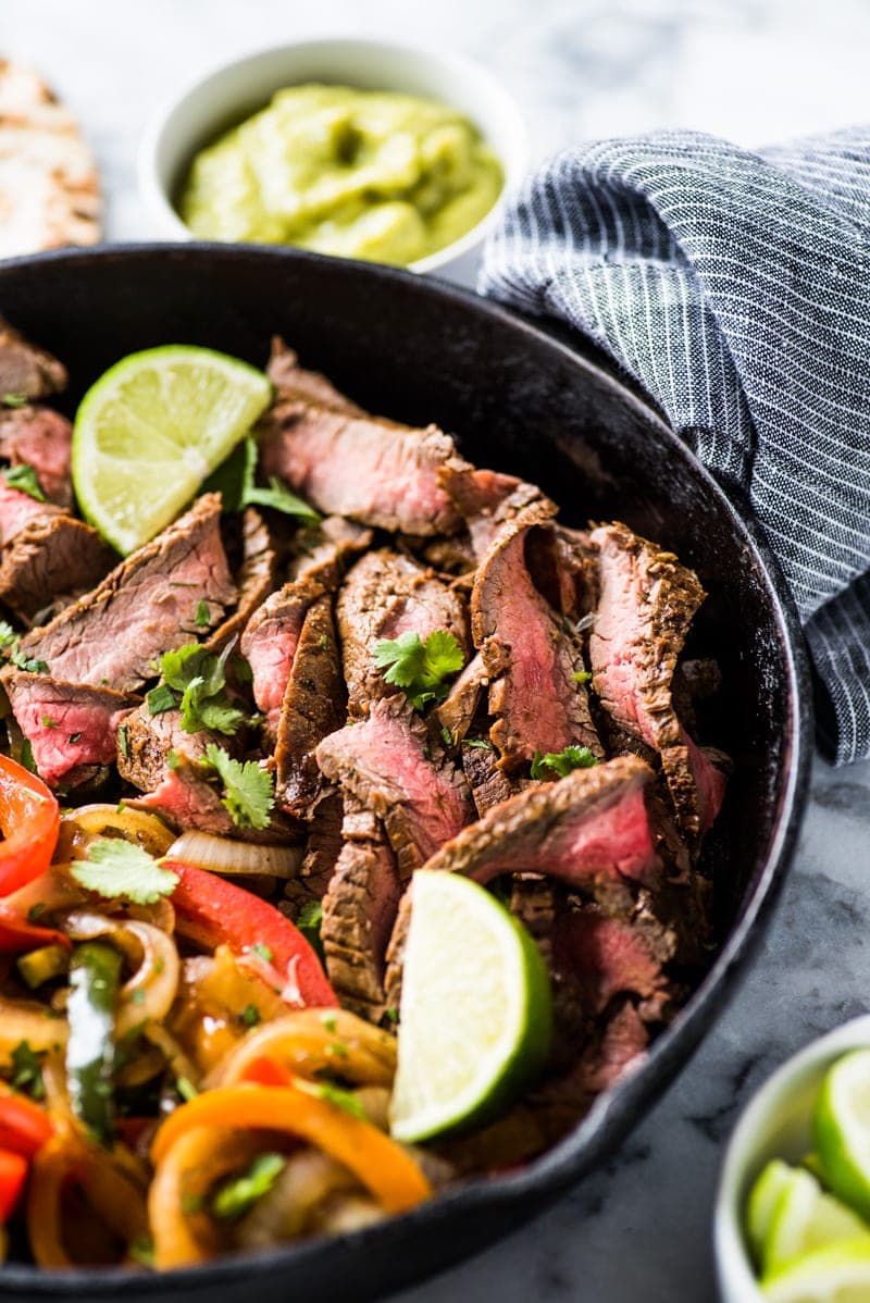 This Steak Fajita Marinade is made with olive oil, orange juice, lime juice, garlic and flavorful herbs and spices that result in tender and juicy fajitas!