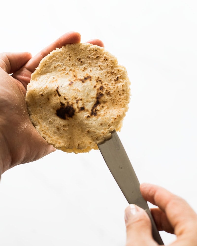 Cutting open a gordita with a knife