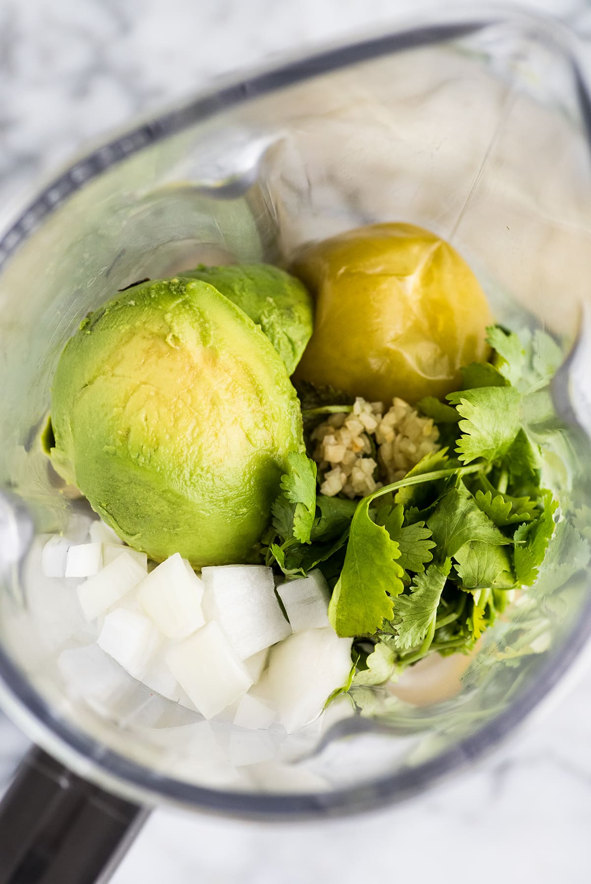 Guacamole salsa ingredients in a blender.