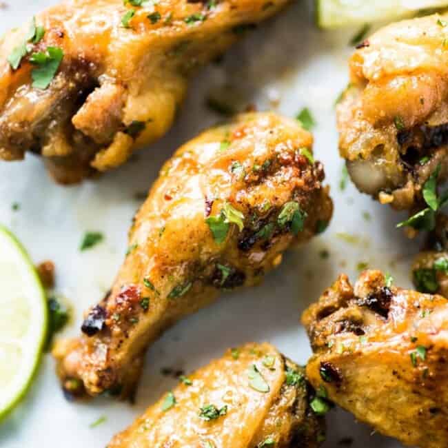This baked chicken wings recipe creates flavorful crispy wings without using extra flours or coatings! Topped with a finger-licking good honey lime sauce, these wings are gluten free, low carb and paleo.