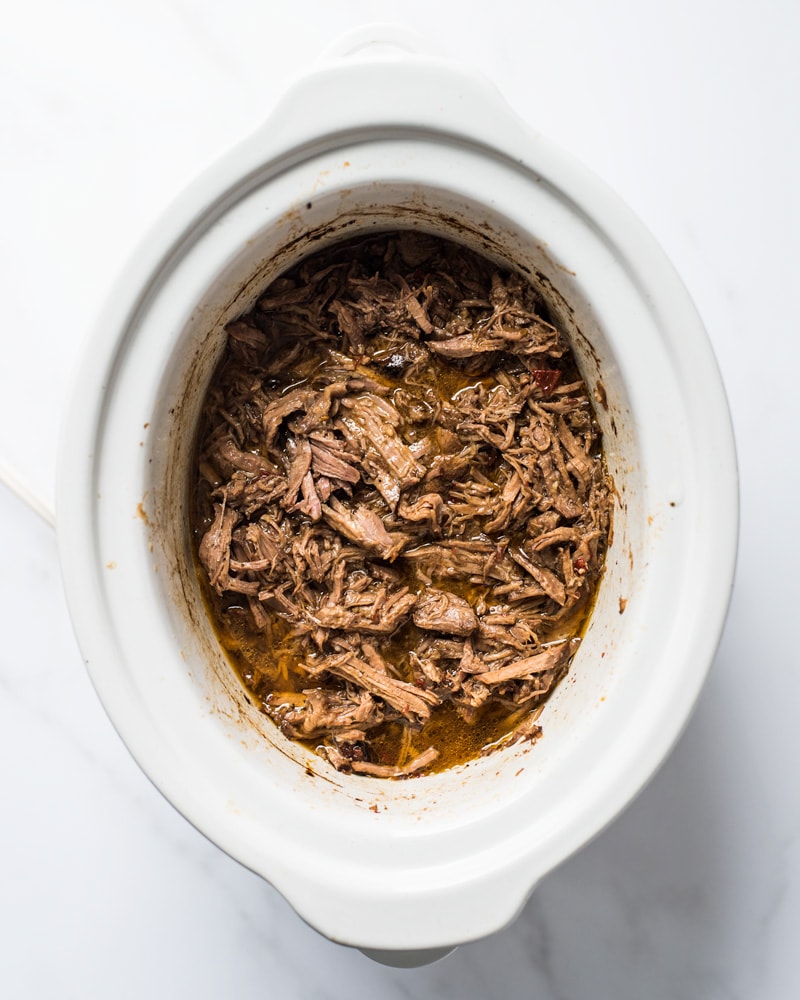 Shredded barbacoa beef in a slow cooker that can be served in tacos, salads, burritos and more!
