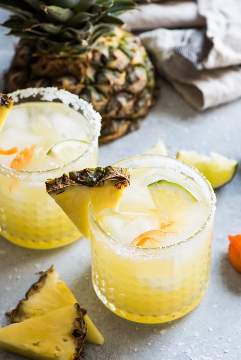 This pineapple margarita is made with sweet pineapple juice and a fresh habanero pepper for a spicy twist on a refreshing cocktail!