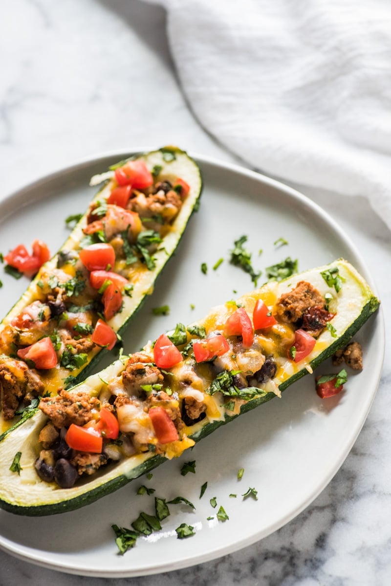 Ground Turkey Zucchini Boats on a plate garnished with cilantro