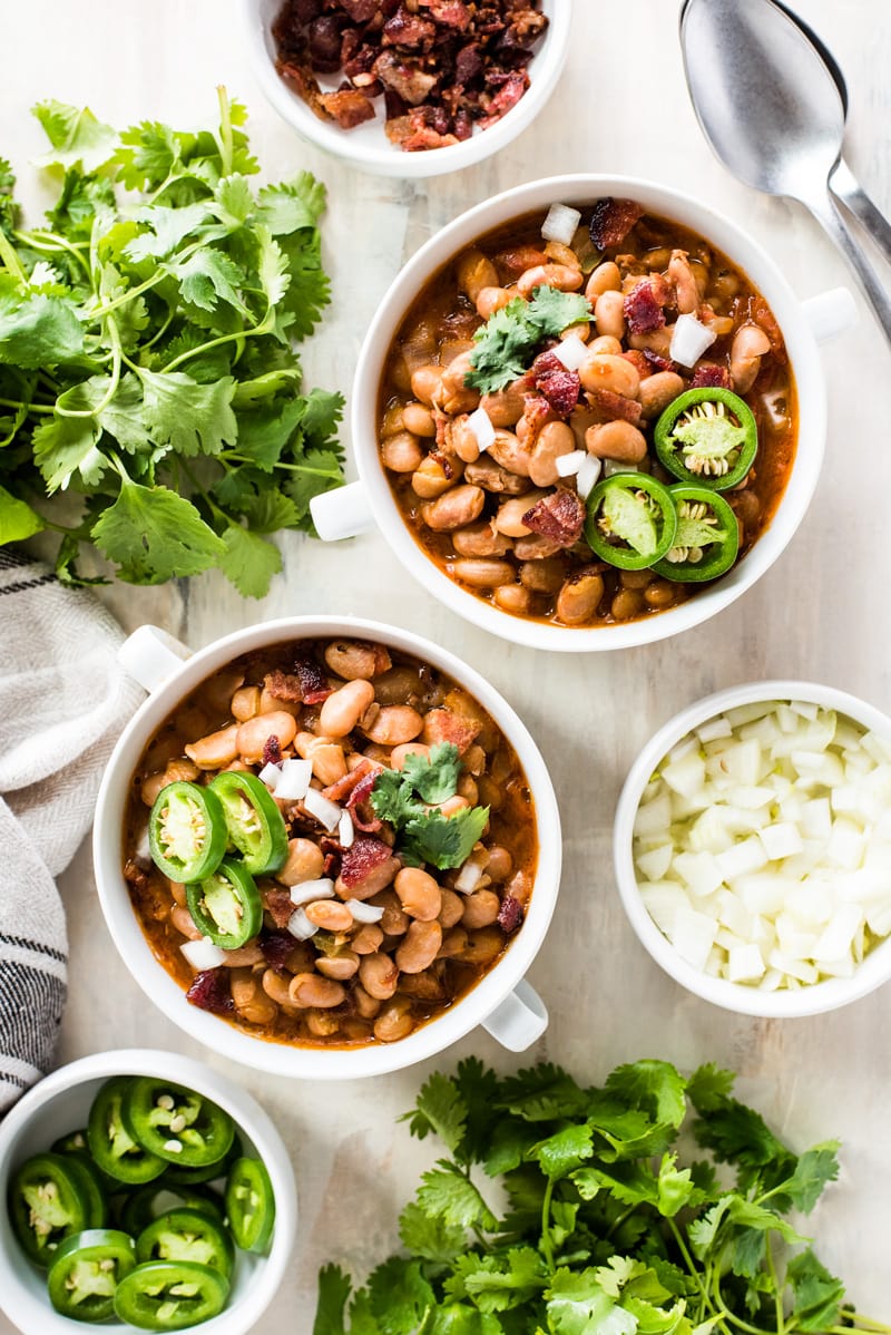 Frijoles Beans are Mexican-style pinto beans cooked in a broth made from bacon, onions, garlic, chipotle peppers, tomatoes and other delicious spices. Great as a side dish or as a full meal served with some cornbread!