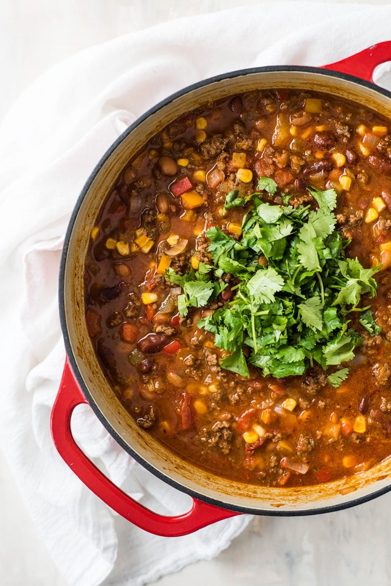 Easy taco soup in a large red pot with cilantro on top.