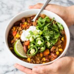 This taco soup recipe is hearty, healthy and ready in only 1 hour! An easy and healthy meal cooked up on the stovetop, serve it with your favorite taco toppings and tortilla chips for a little crunch! (gluten free, freezer friendly) #tacosoup #souprecipe #mexicanfood