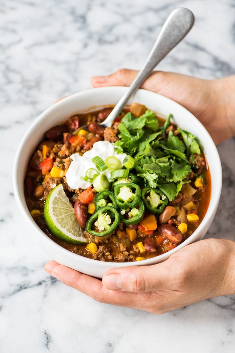 This taco soup recipe is hearty, healthy and ready in only 1 hour! An easy and healthy meal cooked up on the stovetop, serve it with your favorite taco toppings and tortilla chips for a little crunch! (gluten free, freezer friendly) #tacosoup #souprecipe #mexicanfood