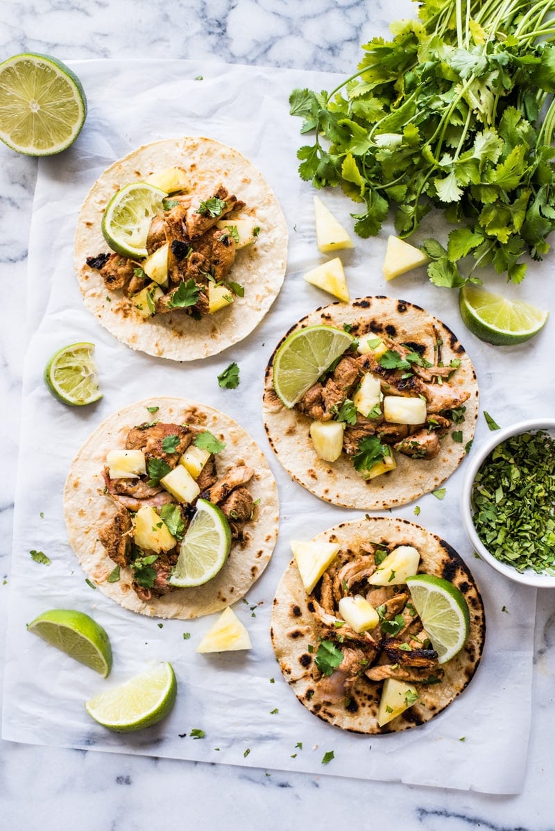 Mexican Tacos Al Pastor made with sweet, tangy and smokey marinated pork grilled to perfection and served with fresh pineapple. The best summer tacos!