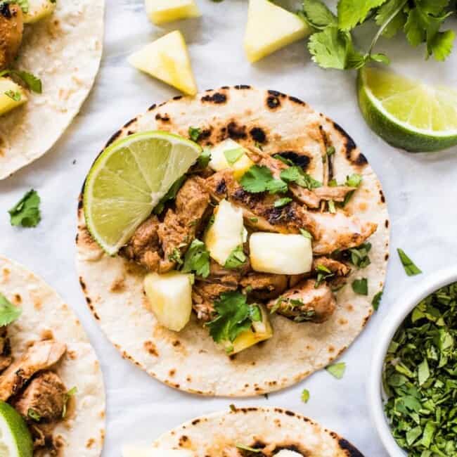 Mexican Tacos Al Pastor made with sweet, tangy and smokey marinated pork grilled to perfection and served with fresh pineapple. The best summer tacos!