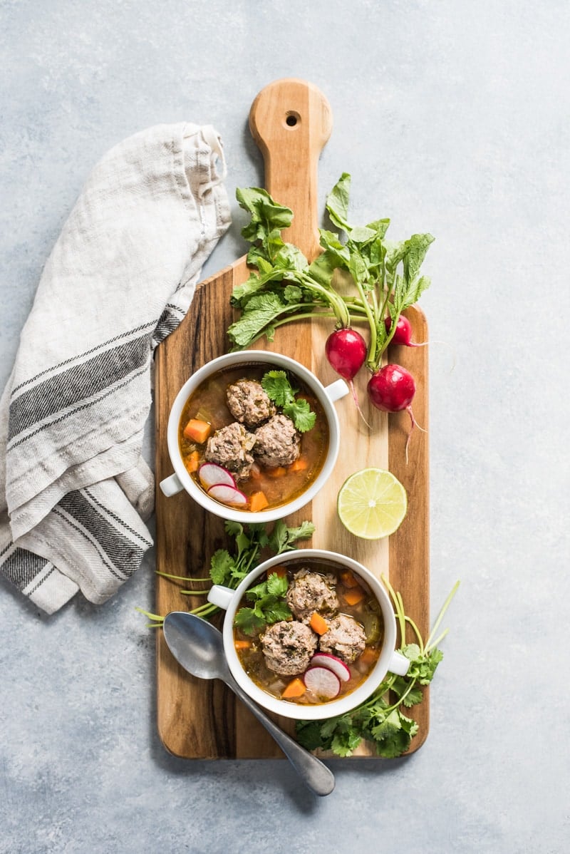This Albondigas Soup, an authentic Mexican meatball soup, is served in a light and healthy broth full of vegetables and and lean protein! (gluten free, paleo) | isabeleats.com
