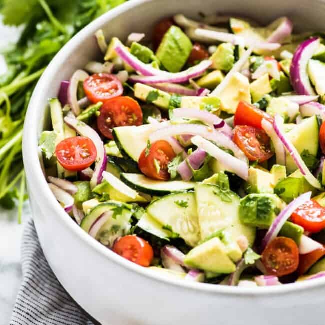 This Avocado Salad recipe is a healthy, fresh and insanely addicting side dish perfect for bbqs, potlucks and get togethers! Ready in only 10 minutes, this recipe is low carb, gluten free, paleo, vegetarian and vegan.
