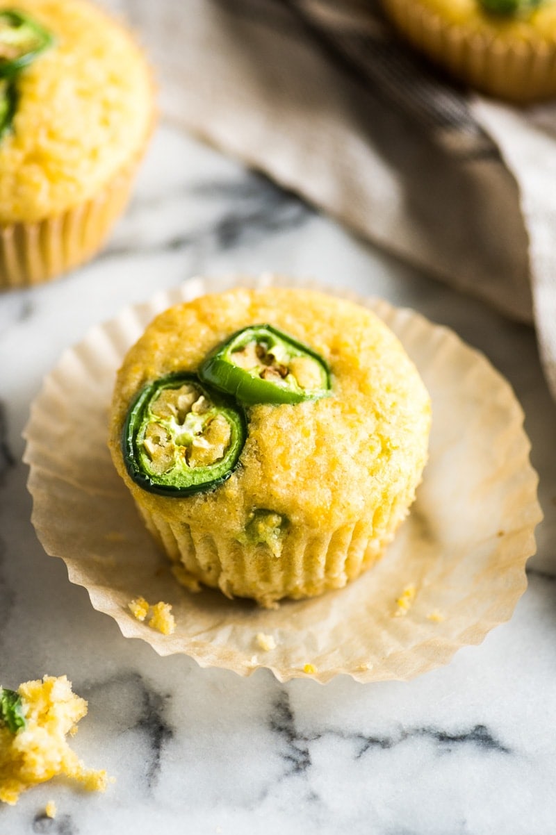 Jalapeno cornbread topped with jalapeno slices with crumbs around it.