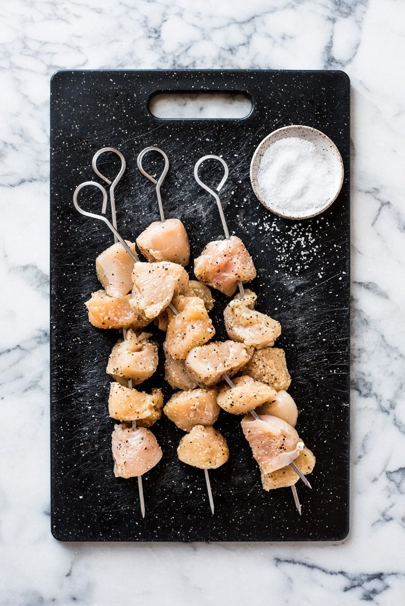 Chicken kabobs seasoned with kosher salt and black pepper.