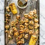 Grilled chicken kabobs on a baking sheet.