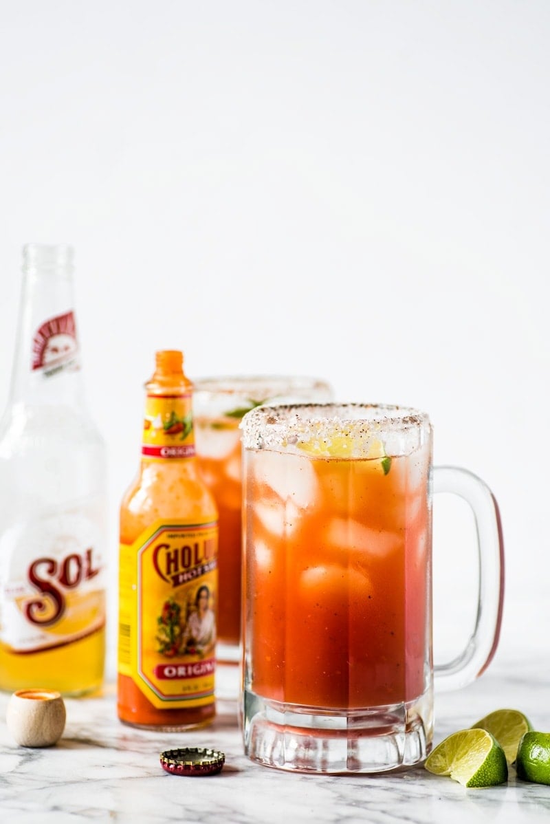 A Michelada in a glass rimmed with salt and Tajin seasoning.